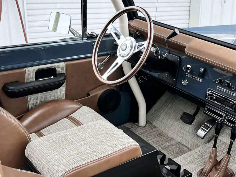 Classic Ford interior passenger side angle of driver seat and steering wheel after detailing